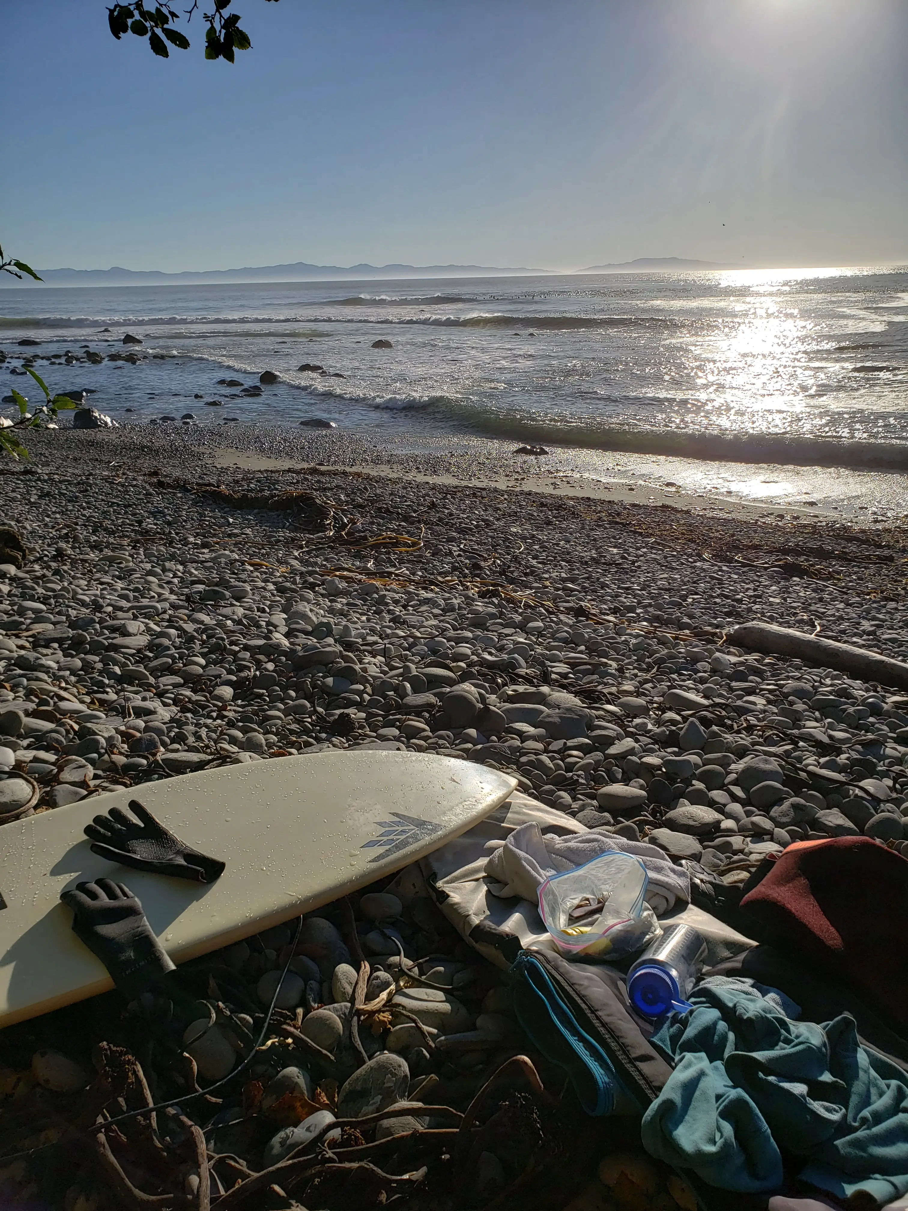 Surfboard on Sombrio Beach rocky shoreline Port Renfrew Vancouver Island