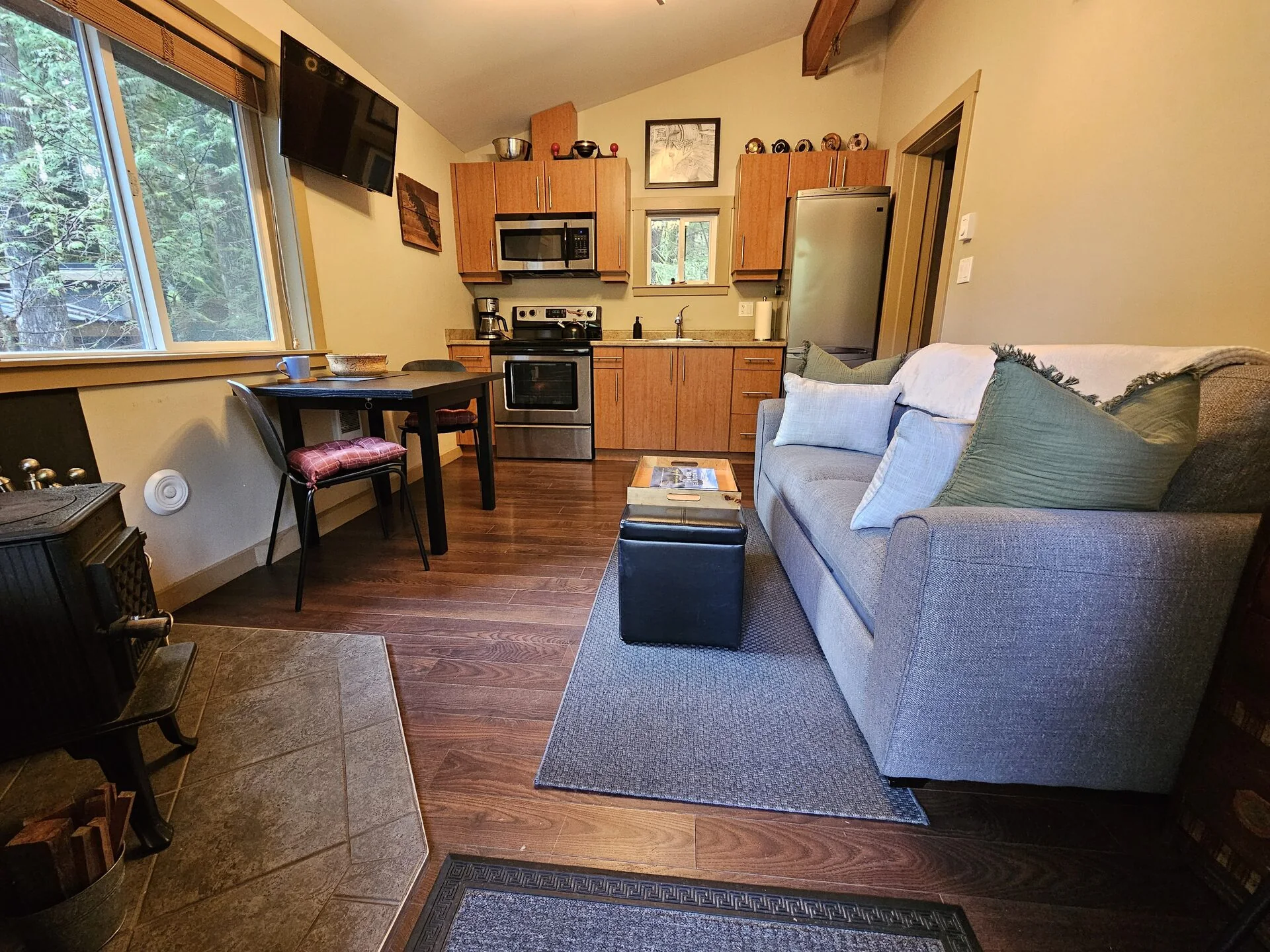 Bright living room with sofa and wood floors at Rachael's Retreat Port Renfrew