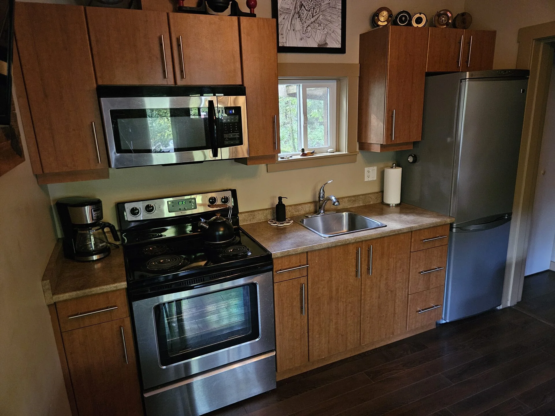 Fully equipped kitchen with stainless appliances at Port Renfrew cabin